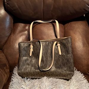 Brown MK purse. Medium shoulder gage with cream colored straps